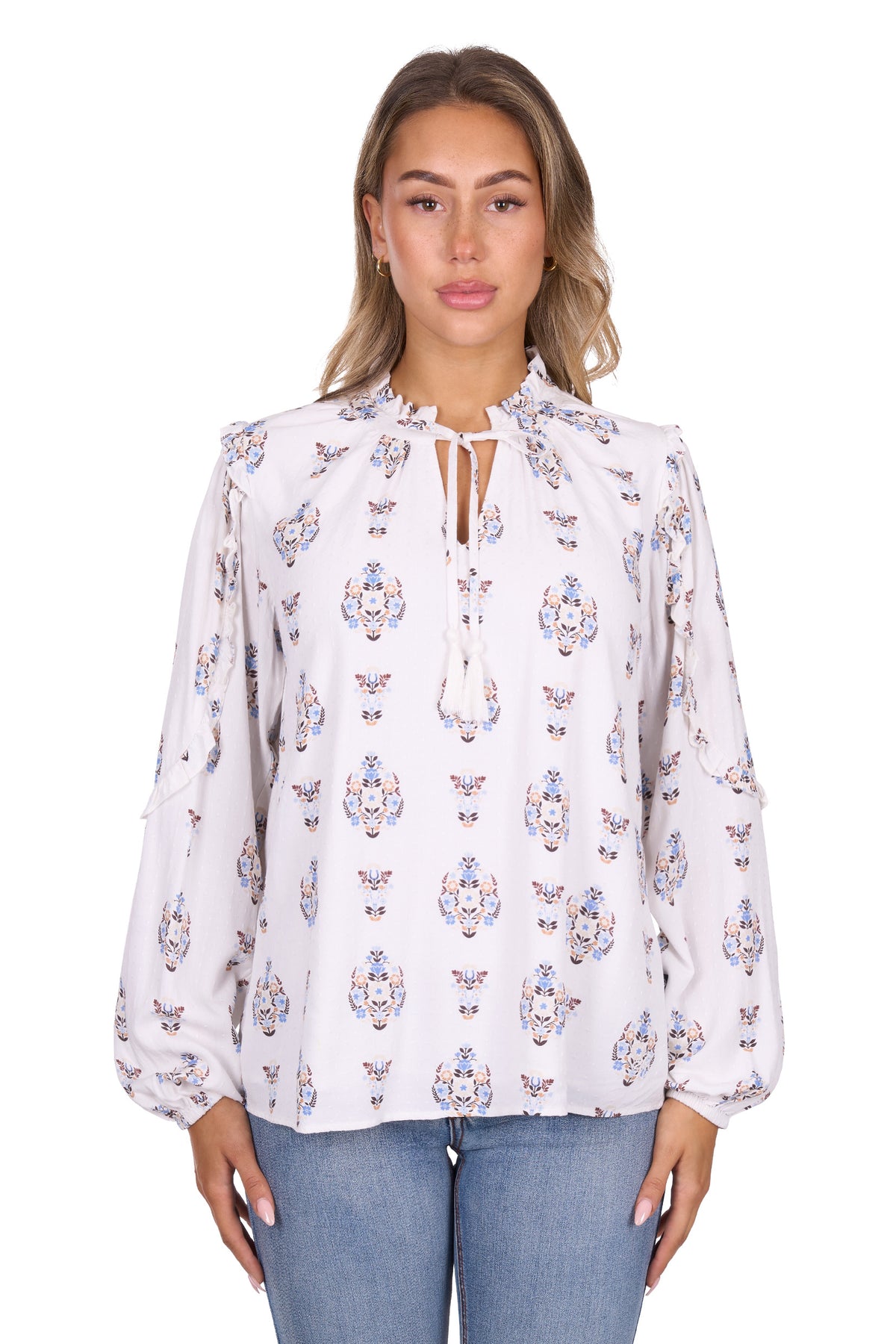 Woman wearing a white blouse with colorful floral patterns on a white background