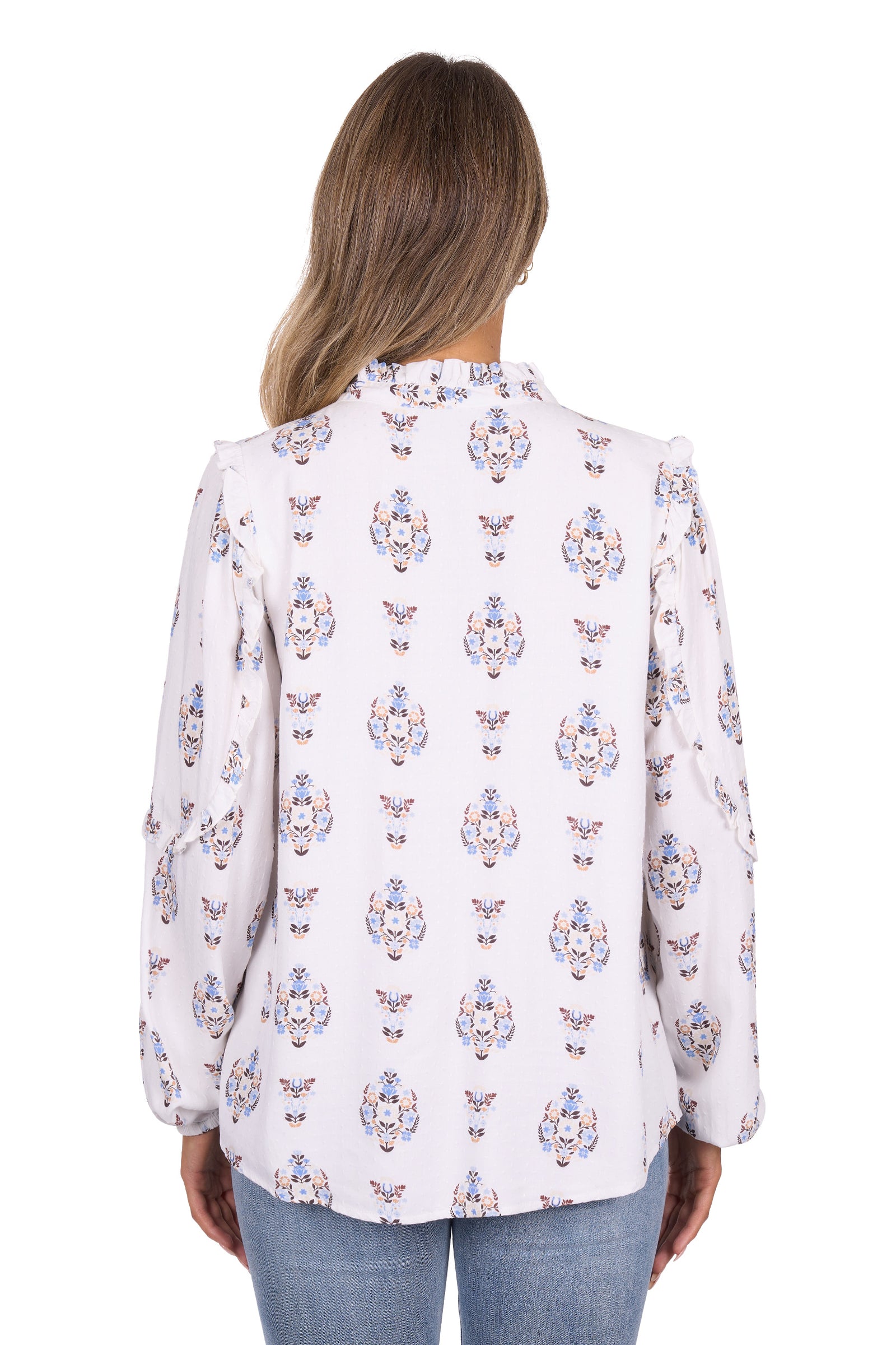 Woman wearing a white blouse with colorful floral pattern on a white background