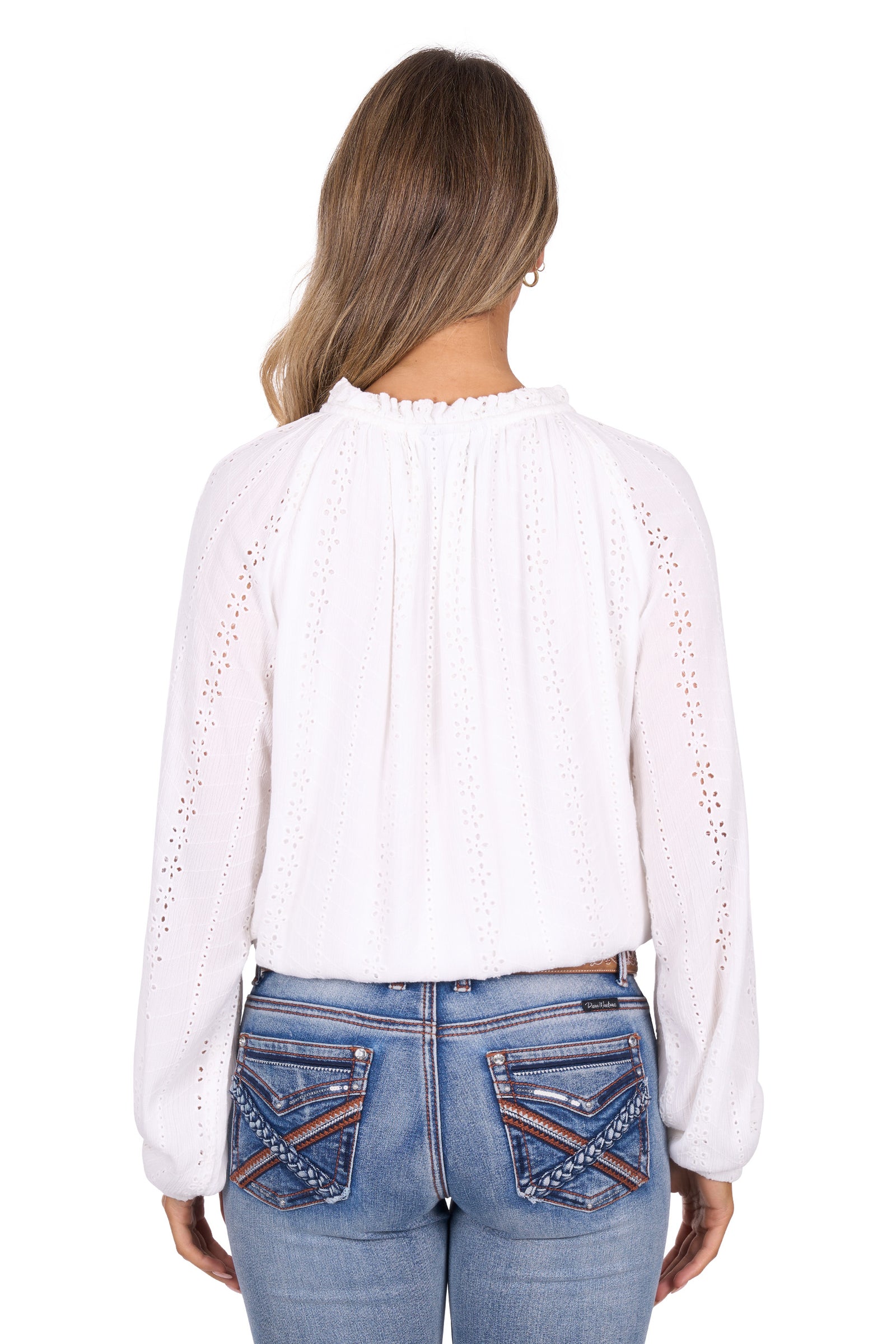 White blouse with cut-out details worn by a person on a white background