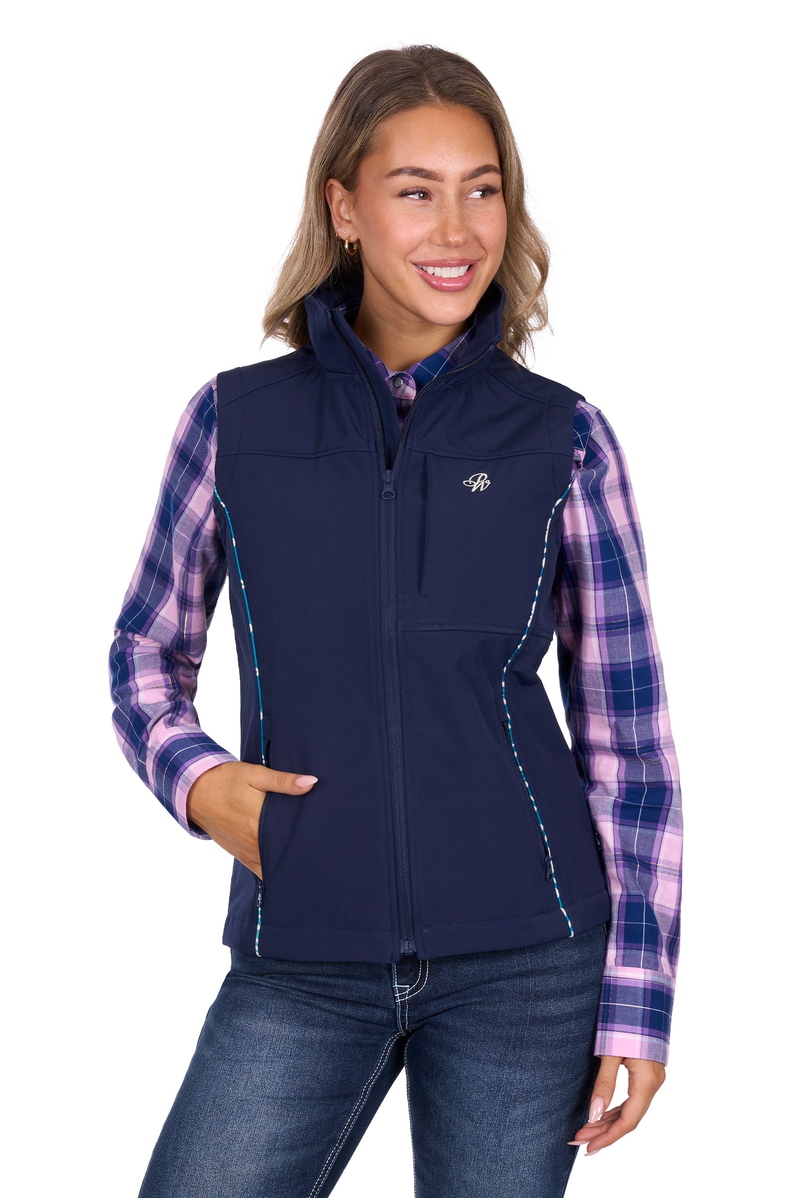 Woman wearing a navy vest over a plaid shirt with a visible logo on a white background