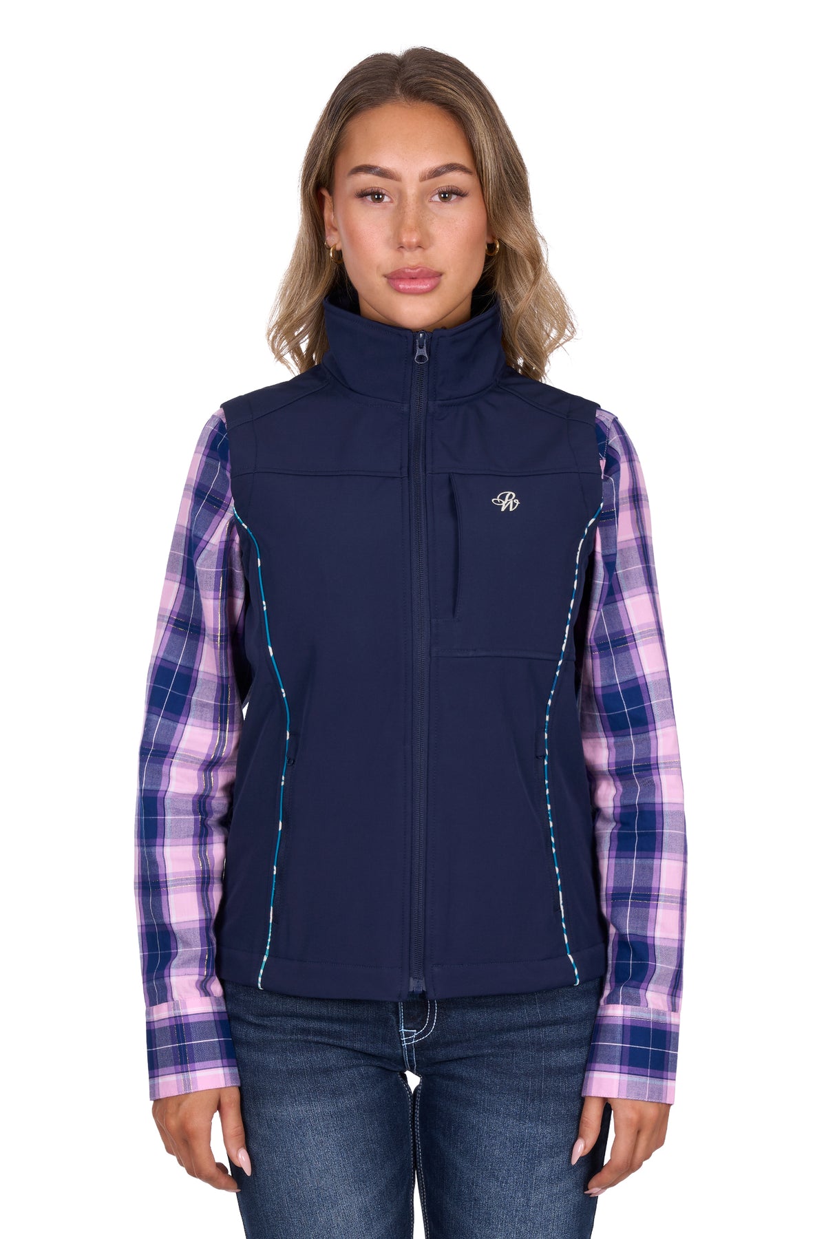 Woman wearing a navy vest over a plaid shirt on a white background