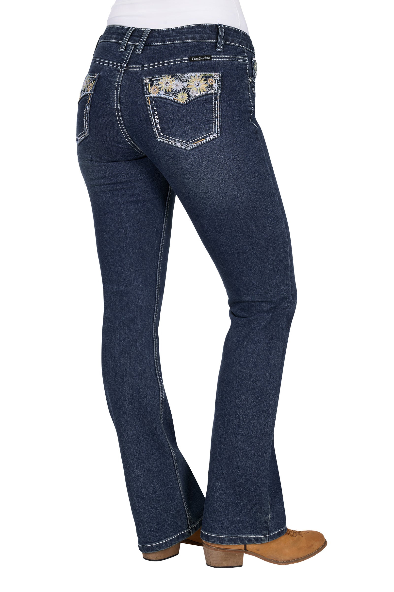 Pure Western Women's Jay Boot Cut Jean. Blue jeans with floral pocket designs on a white background