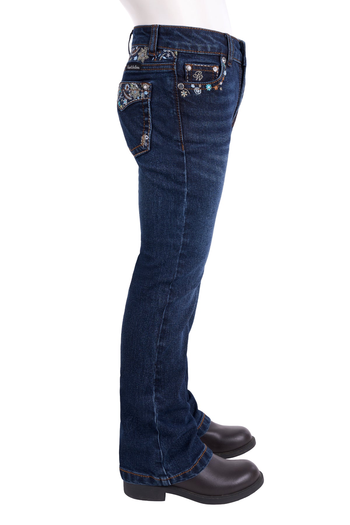 Side view of dark blue denim jeans with silver rhinestone embellishments on the back pockets, shown on a mannequin lower body with black boots against a white background.