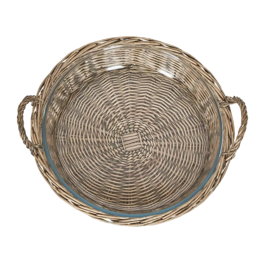 Round Basket with Glass Dish. Woven basket with handles on a light gray background