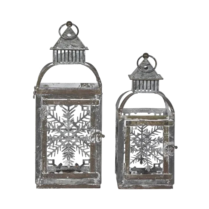 Rustic Tin Christmas Lantern. Two decorative lanterns with snowflake designs on a white background