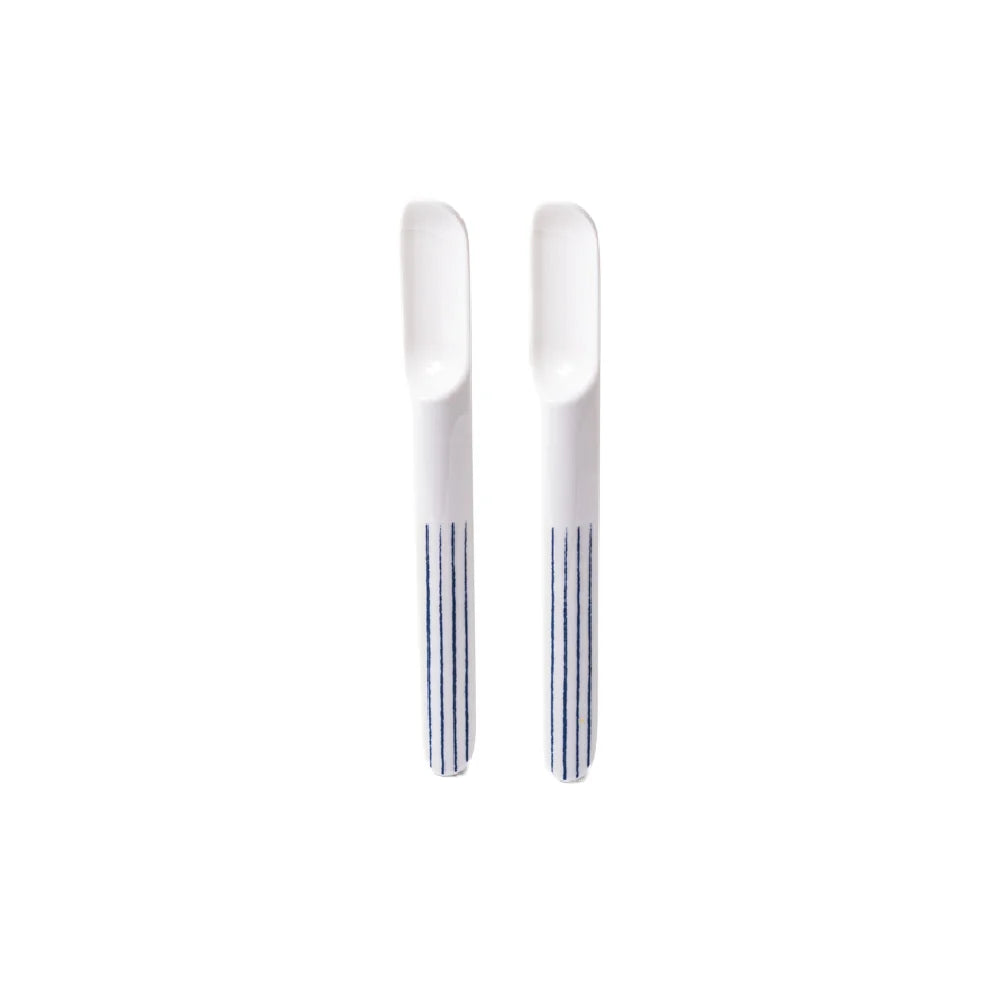 Two silver butter knives on a white background