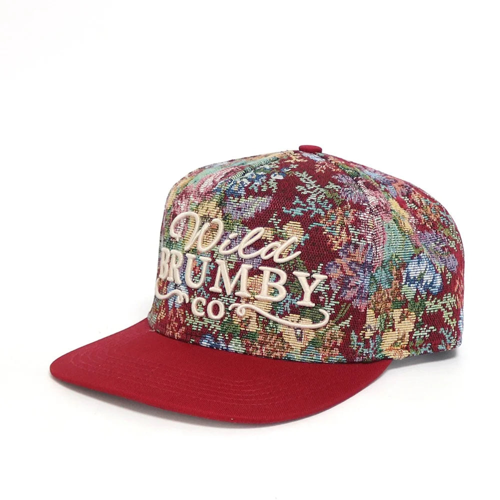 Colorful cap with floral pattern and 'Wild Trumby Co.' text on a white background