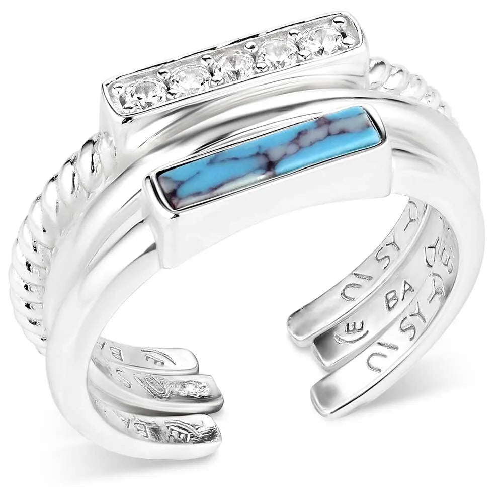 Silver ring with turquoise inlay and diamond accents on a white background
