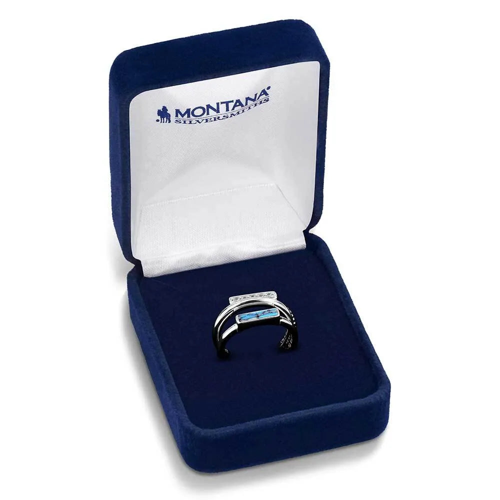 Blue velvet jewelry box with a ring featuring Montana Silversmiths branding on a white background.