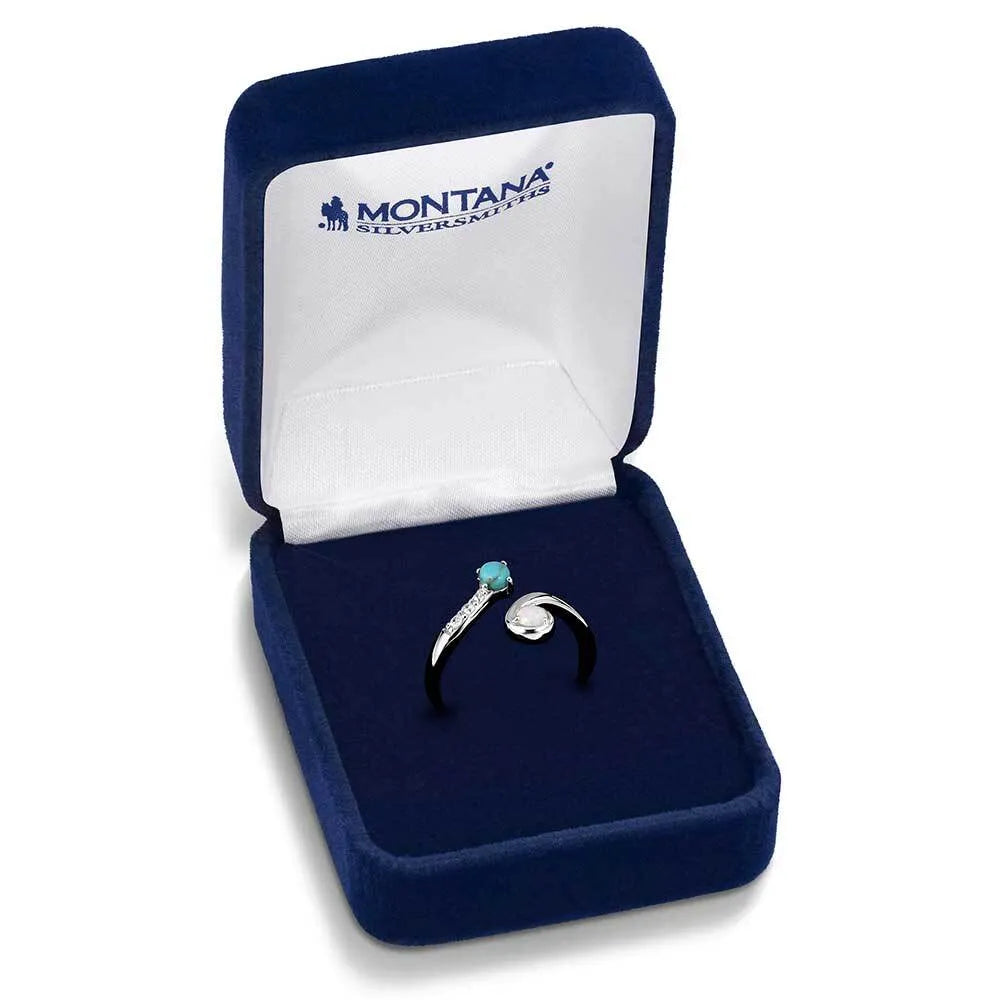Two silver rings with gemstones in a blue jewelry box with 'Montana Silversmiths' branding.