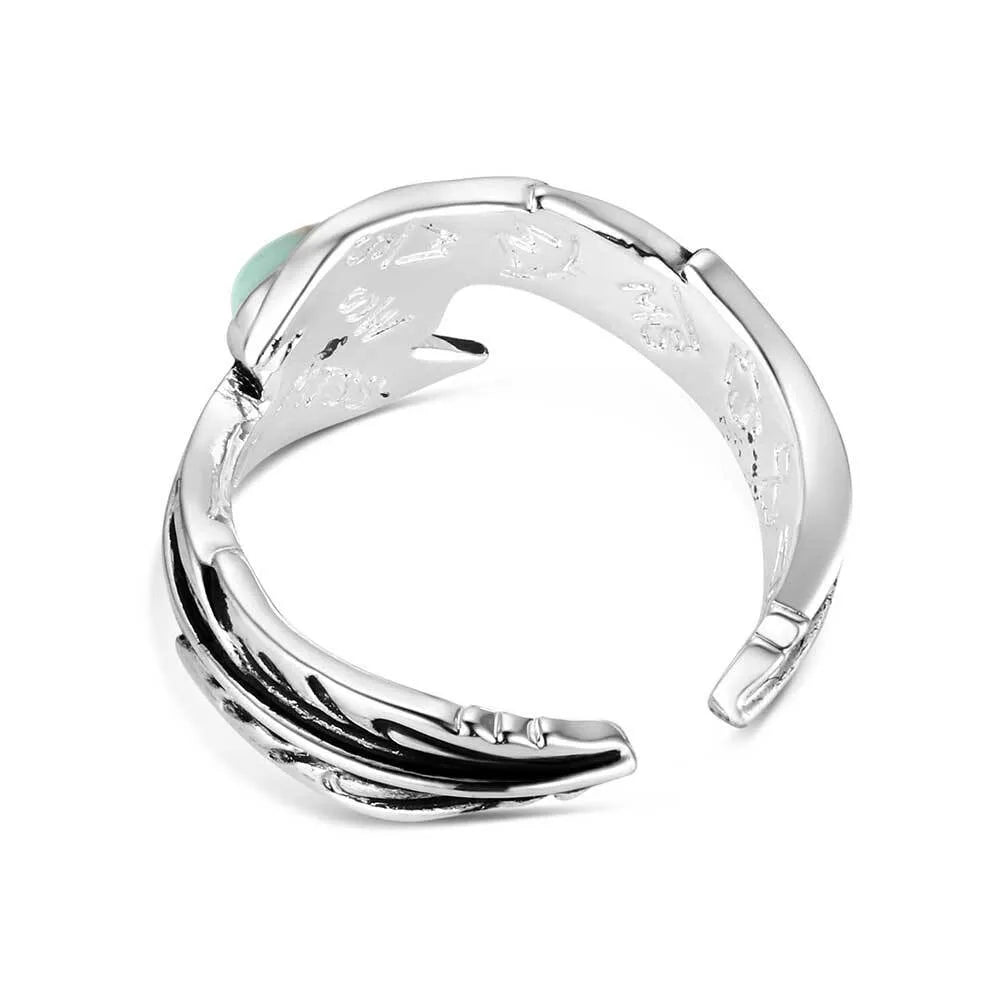Silver ring with a turquoise stone on a white background