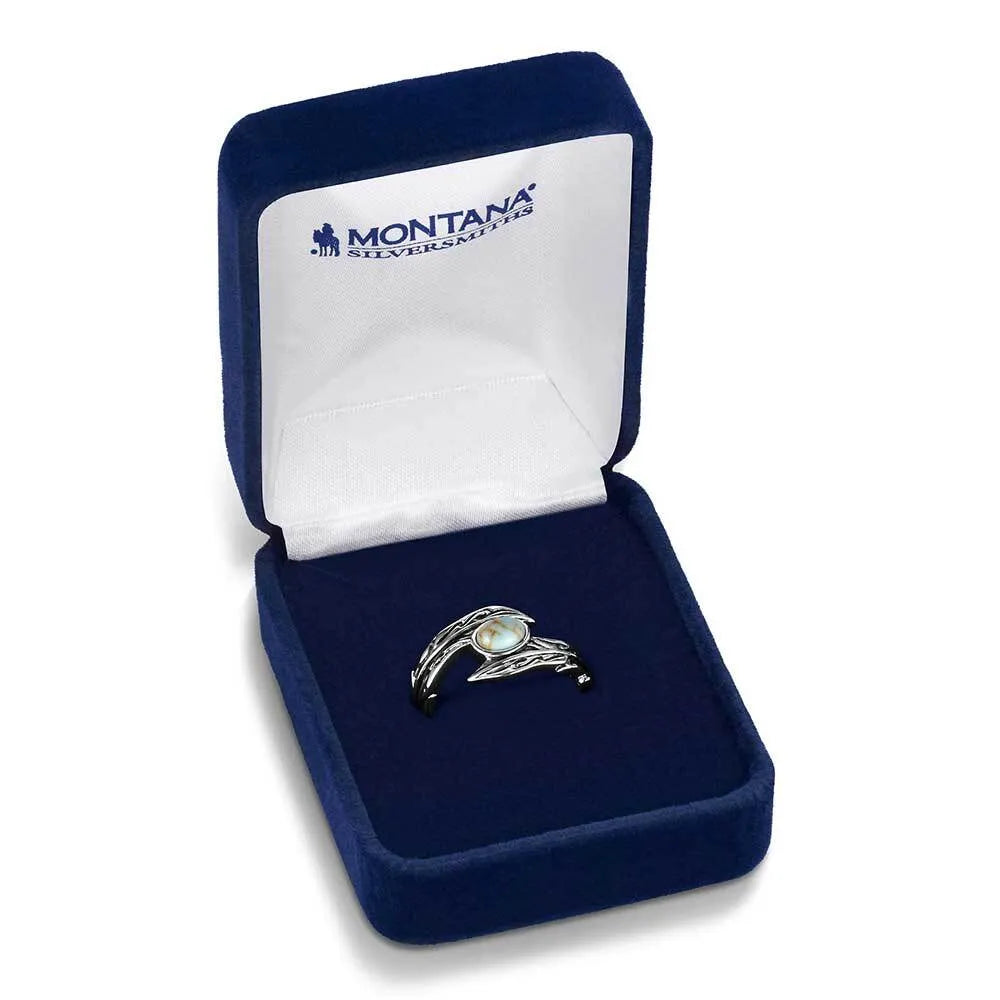Silver ring with a black gemstone in a blue jewelry box with 'Montana Silversmiths' branding.