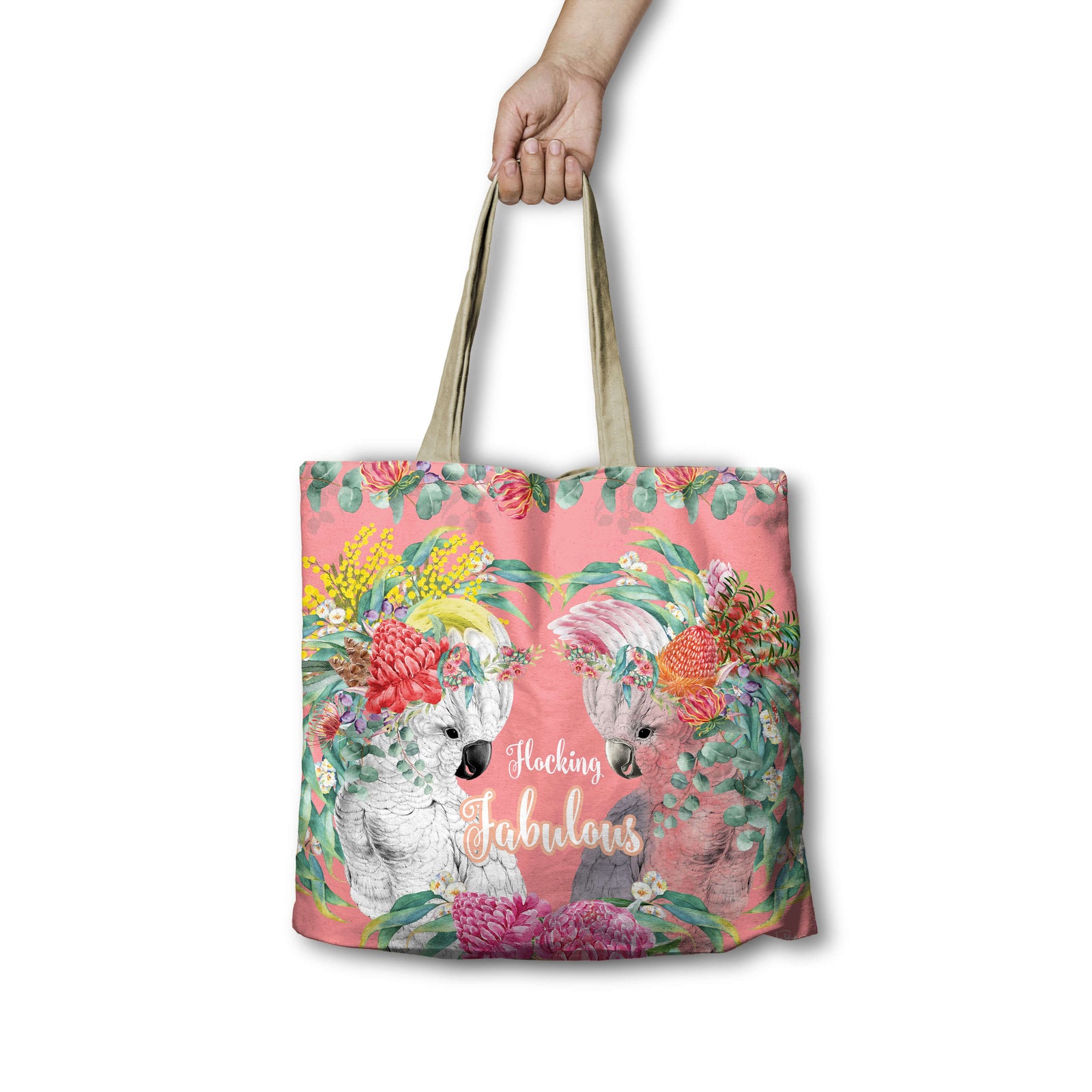 Lisa Pollock Flocking Fabulous Shopping Bag. Tote bag with floral design and text held by a hand on a white background