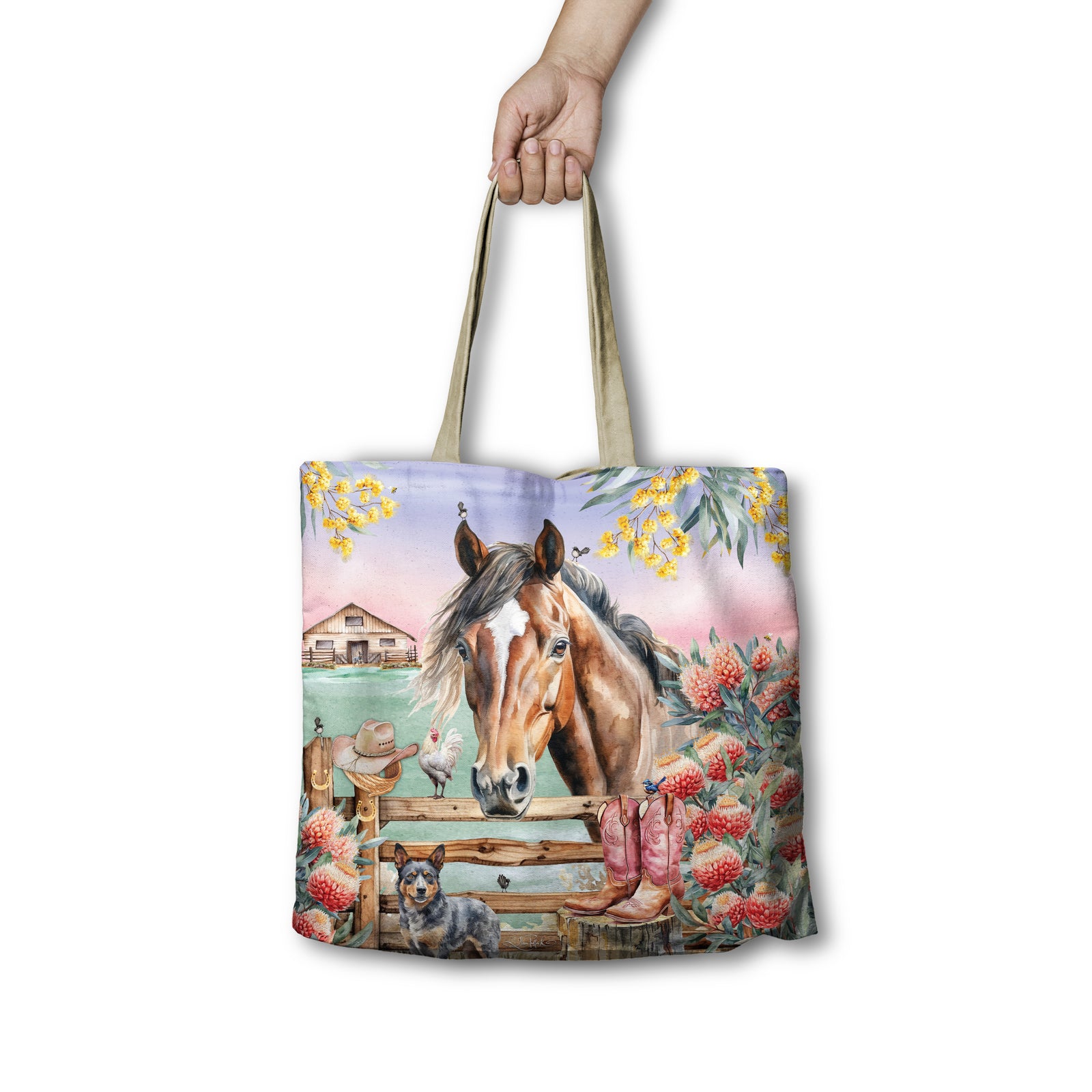 Lisa Pollock Country Dusk Shopping Bag. Tote bag with a horse and farm scene design held by a hand on a white background
