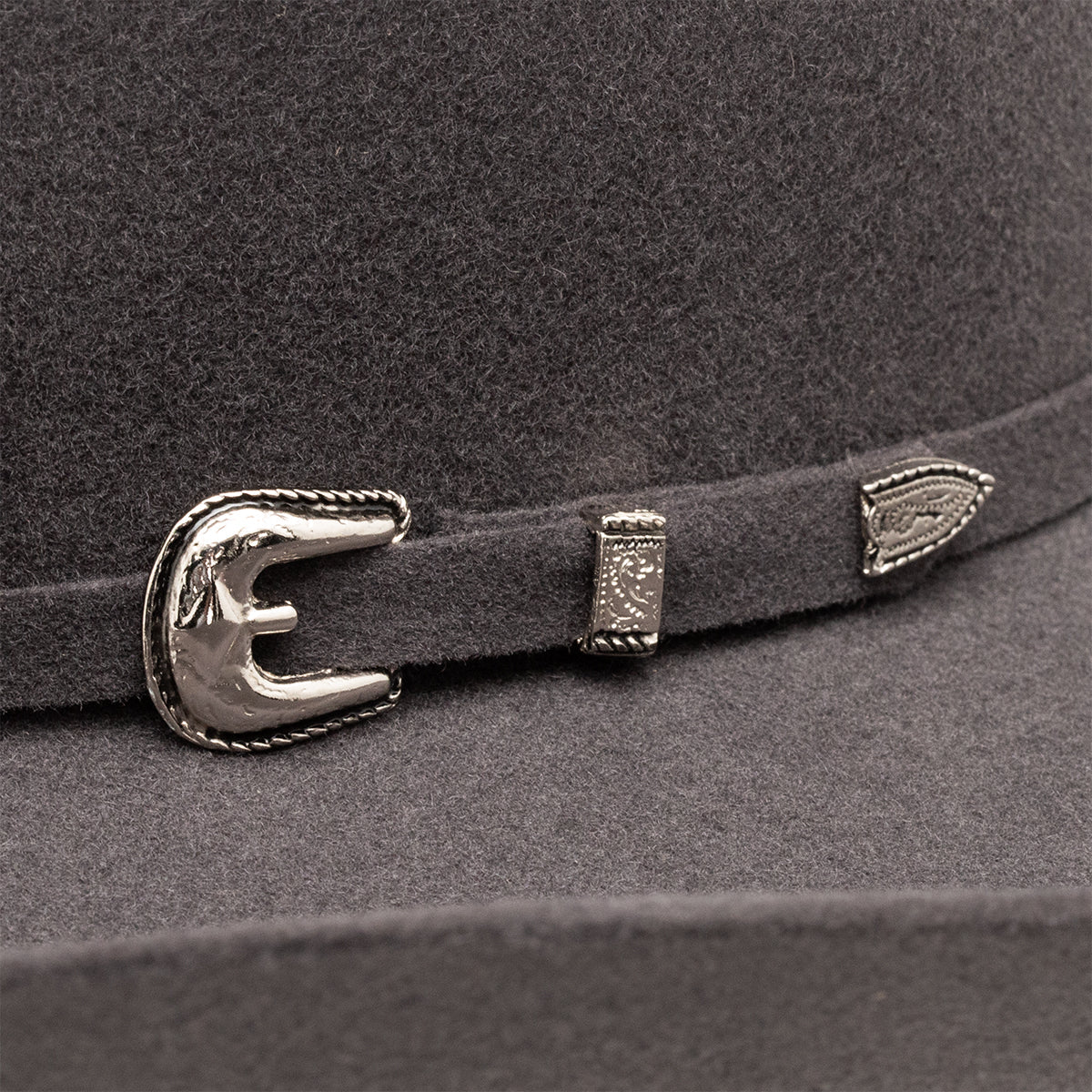 Resistol 3X Pay Window Tuff Hedeman Felt Cowboy Hat. Close-up of a gray hat with a decorative silver buckle and feather.
