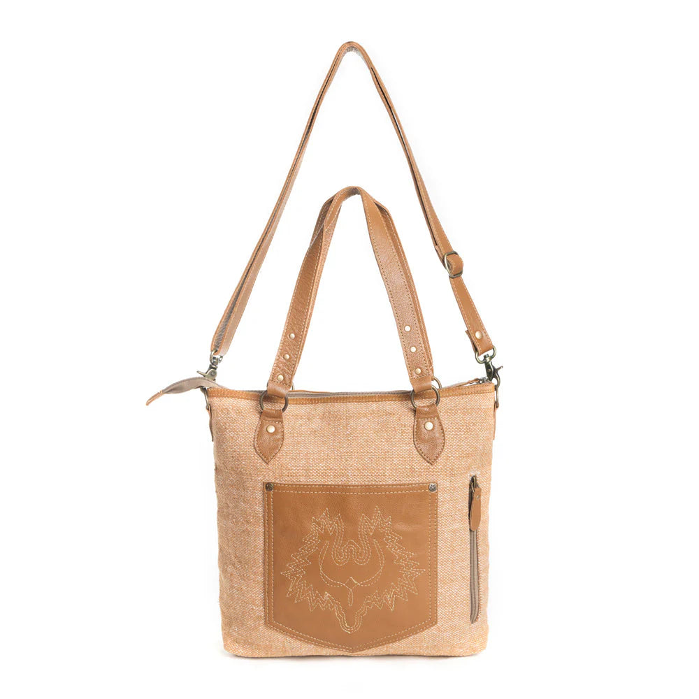 Prairie Magic Messenger BagA beige messenger bag with Southwestern geometric patterns in blue and white, featuring an adjustable shoulder strap and carrying handles. 