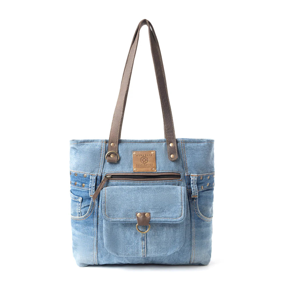 Denim tote bag with brown leather accents on a white background