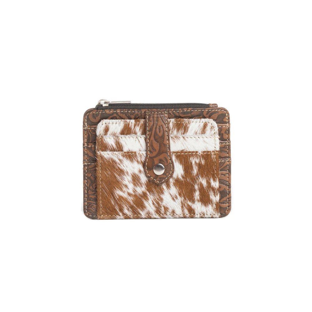 Small wallet with cowhide pattern on a white background