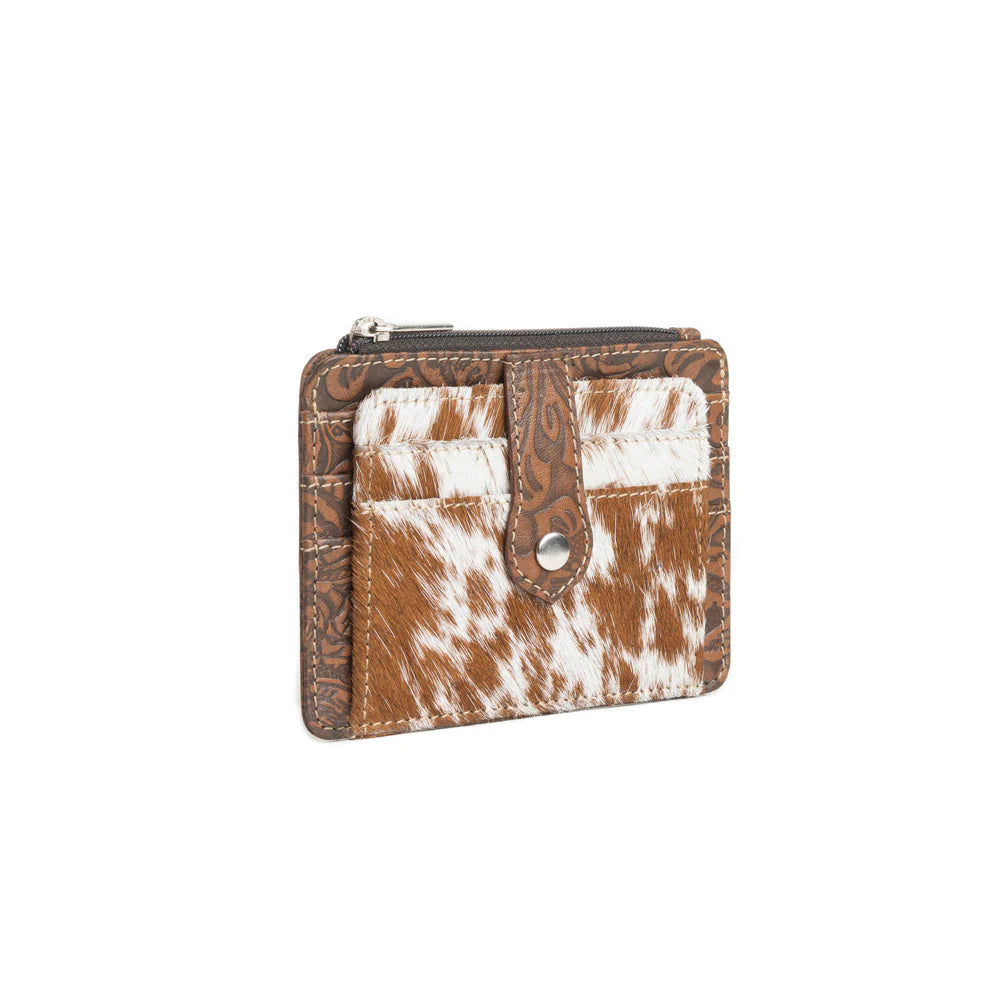Small wallet with brown and white cowhide pattern on a white background
