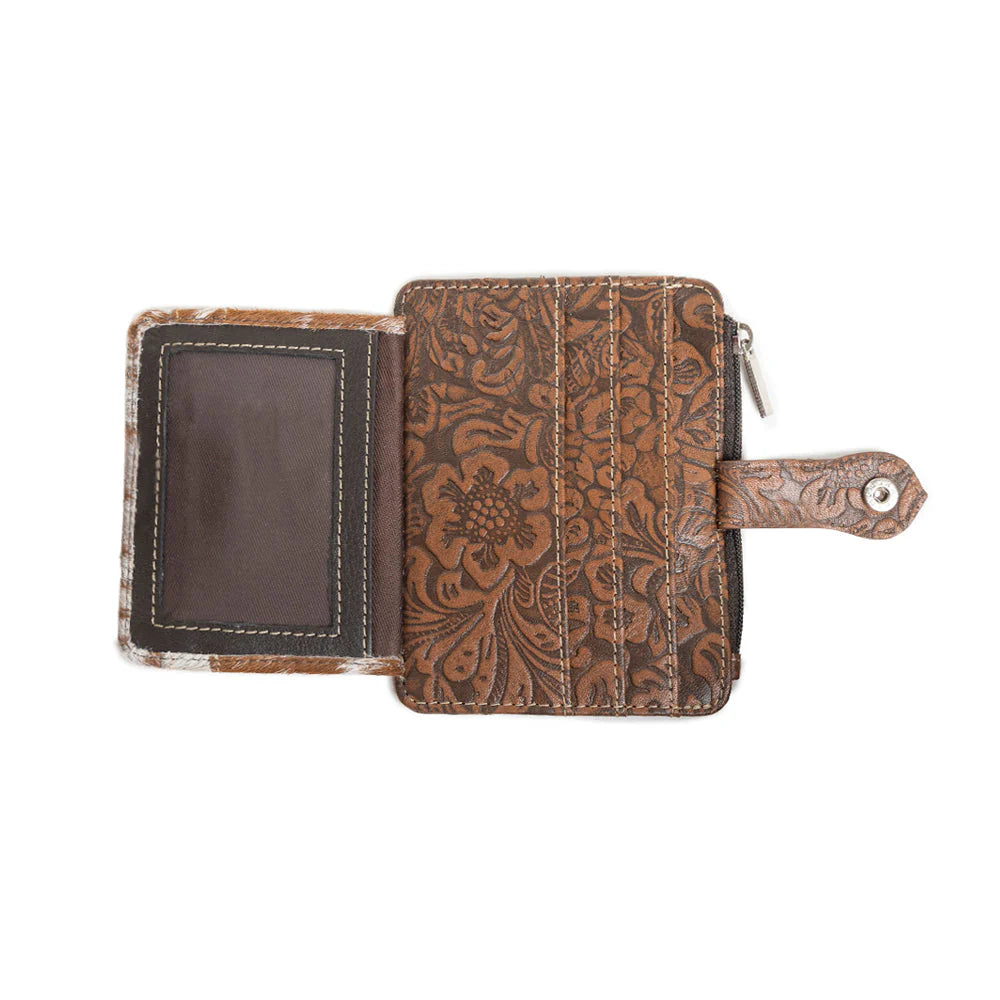 Brown leather wallet with intricate patterns on a white background