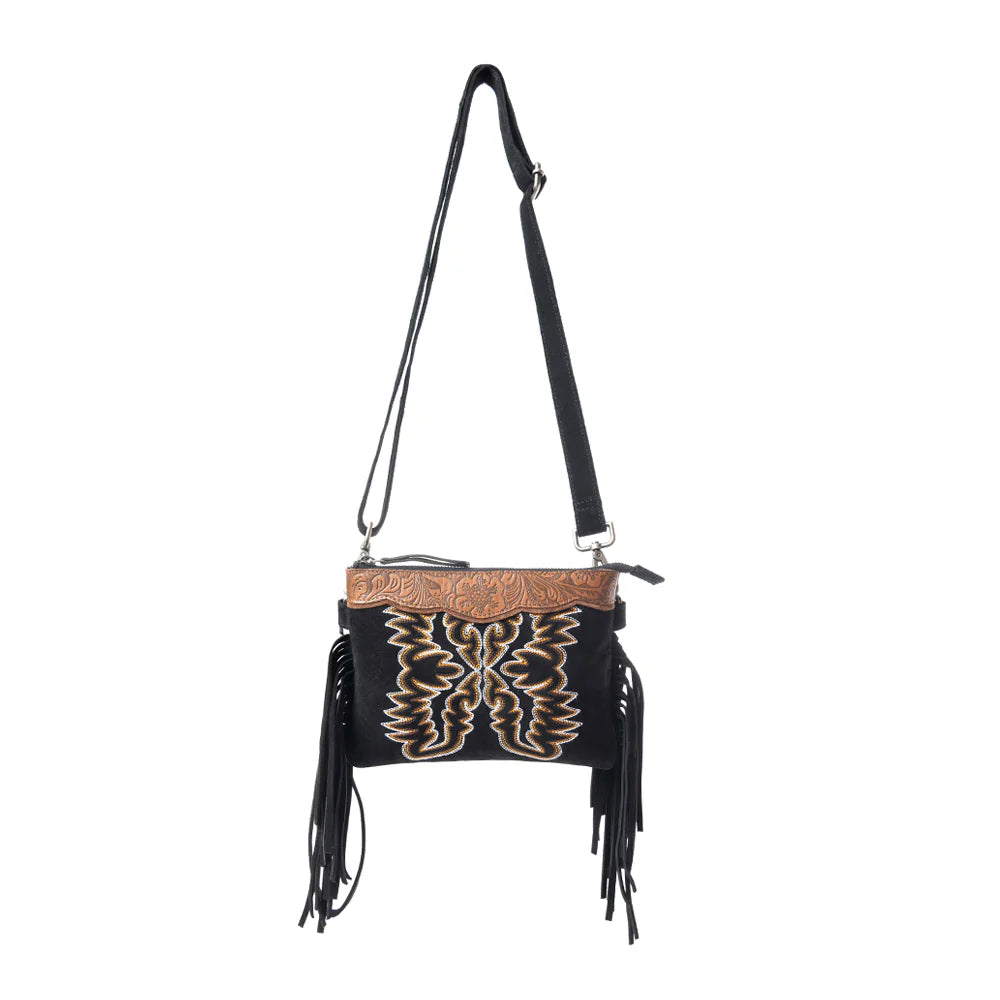 Desert Wing Crossbody Bag In Black. Black handbag with gold embroidery and fringes on a white background