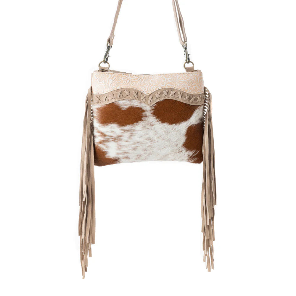 Mesa Rebel Hairon Western Handbag in Spotted Tan. Handbag with cowhide pattern and fringes on a white background