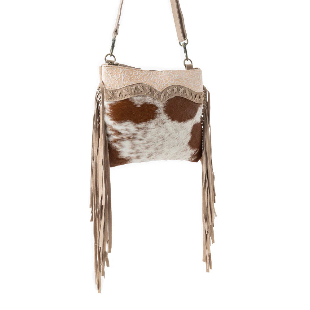 Mesa Rebel Hairon Western Handbag in Spotted Tan. Handbag with cowhide pattern and fringes on a white background