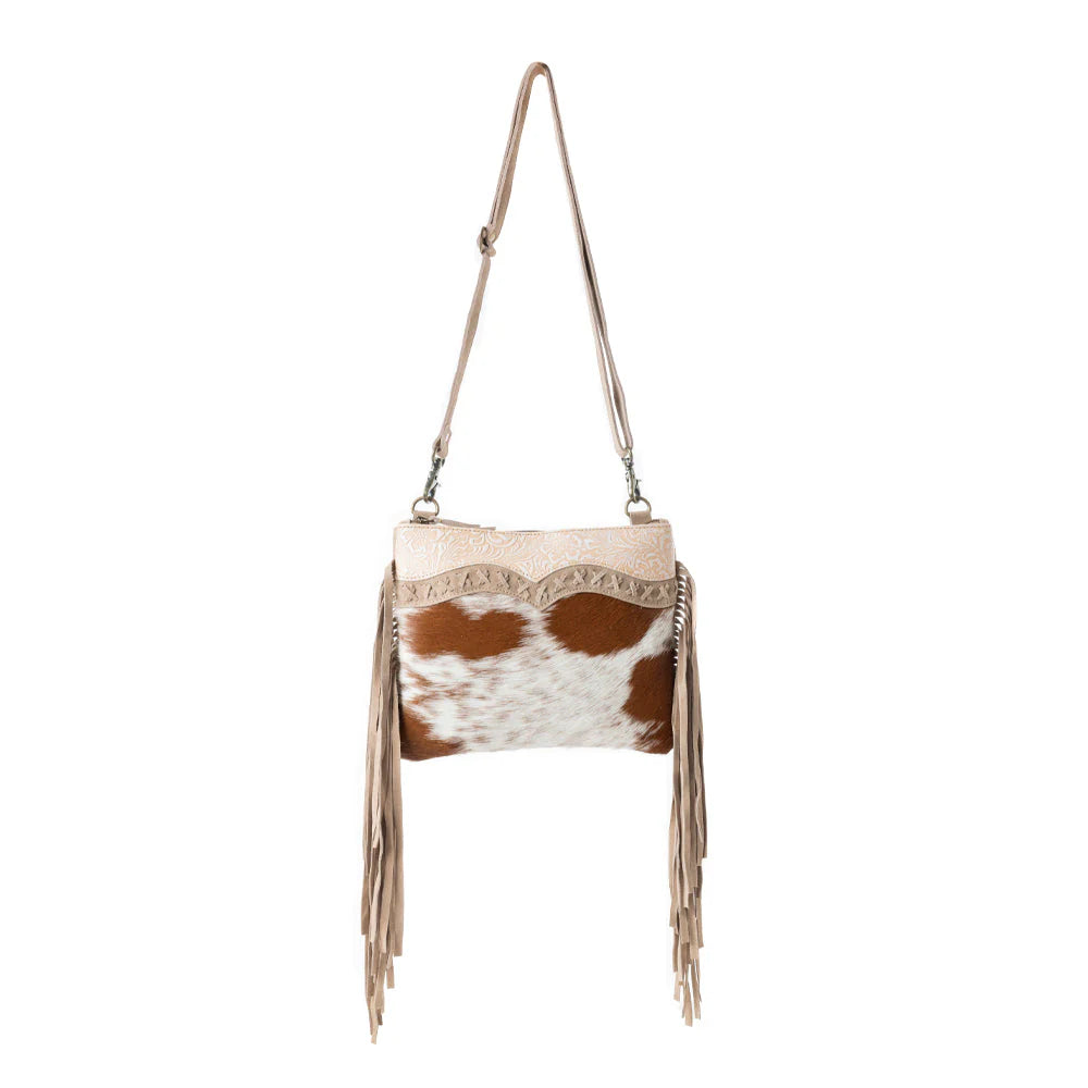 Mesa Rebel Hairon Western Handbag in Spotted Tan. Handbag with cowhide pattern and fringes on a white background