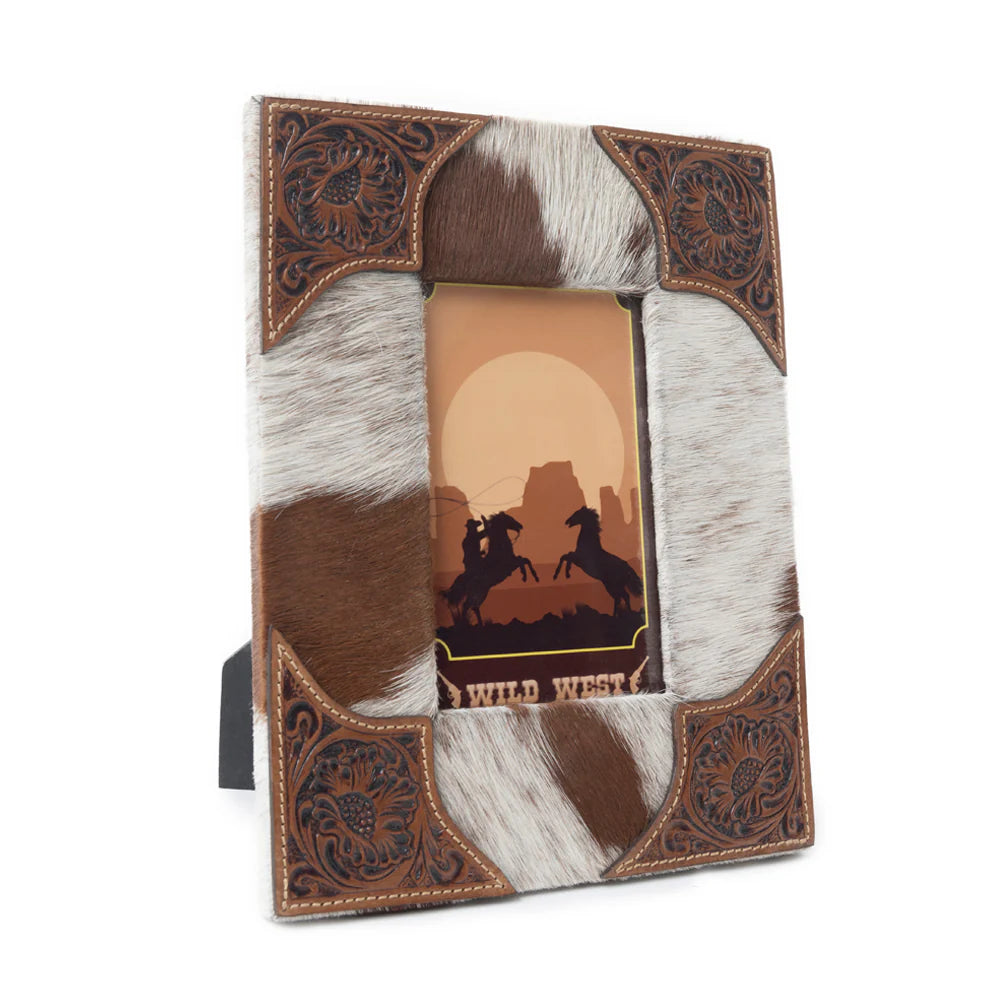 Tumbleweed Trail Photo Frame. A photo frame with brown leather corners and black and white hair-on hide. It includes a picture of two people on horses in a western setting.