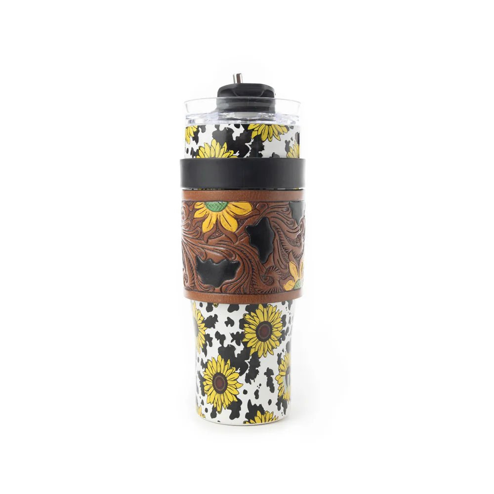Wide Wyoming Tumbler In Yellow with Tooling. Tumbler with sunflower design and brown leather sleeve on a white background