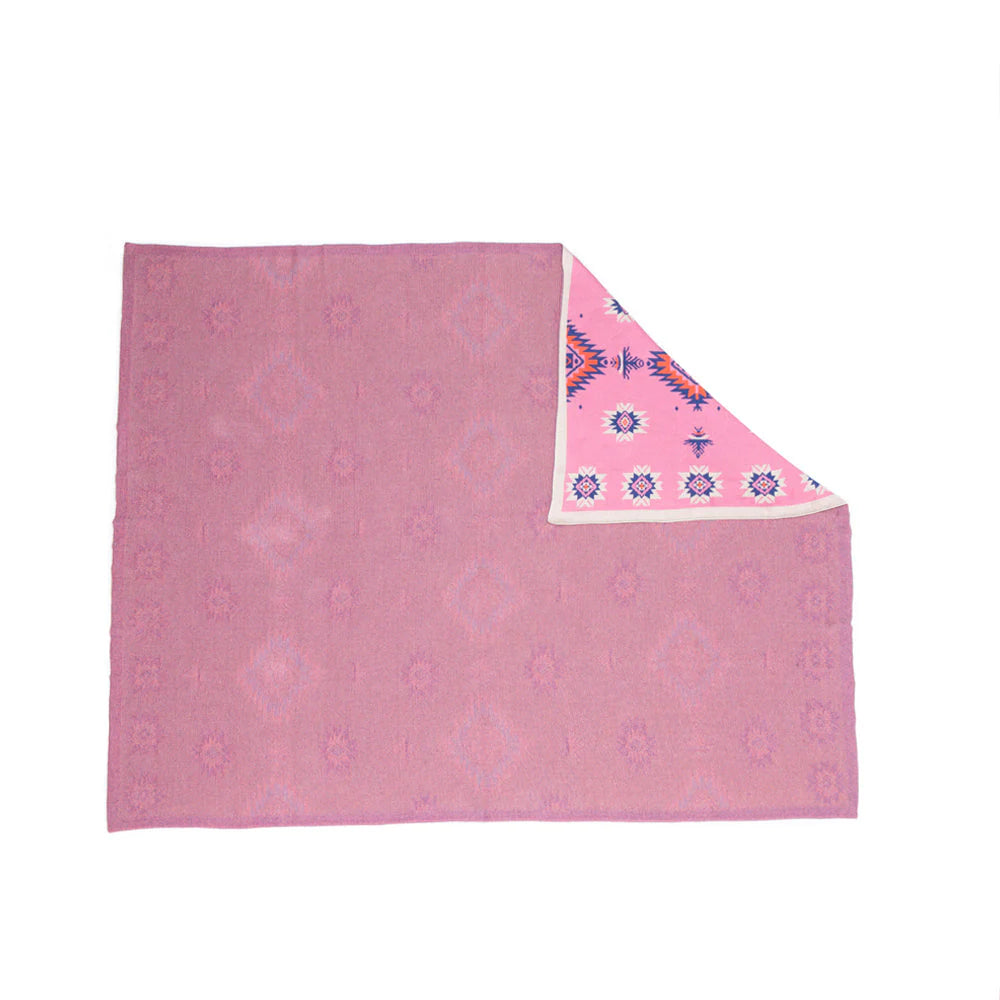 Pink blanket with a geometric pattern on a white background