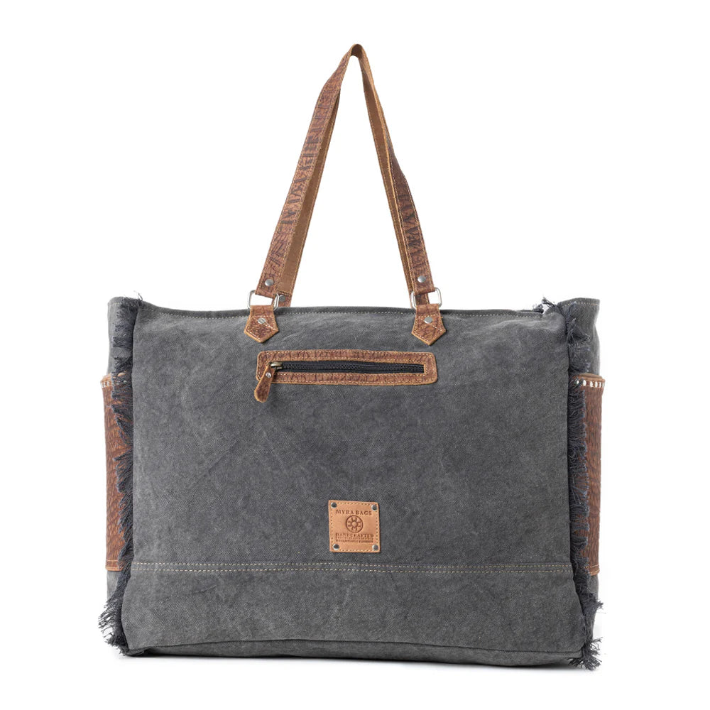 Saddle Belle Weekender Bag in Wild Clay. Gray tote bag with brown leather accents on a white background