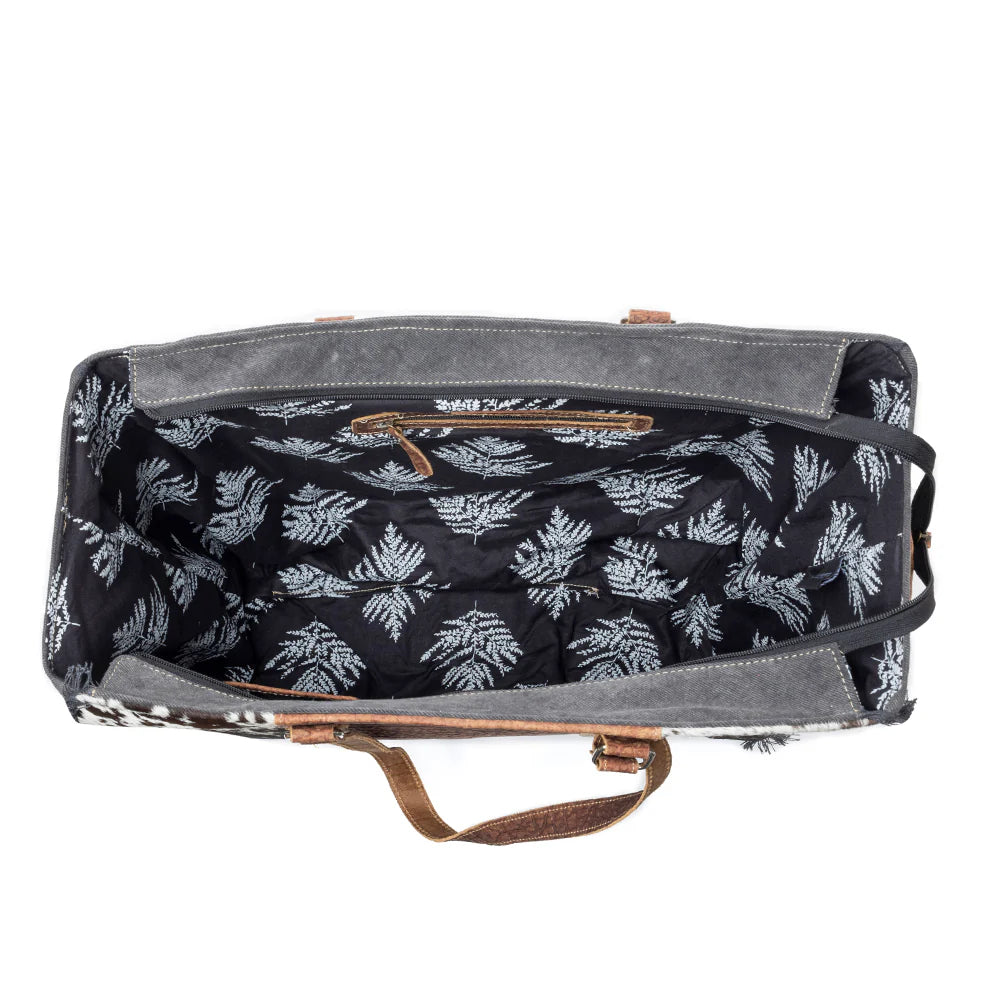 Saddle Belle Weekender Bag in Wild Clay. Canvas bag with floral pattern interior on a white background