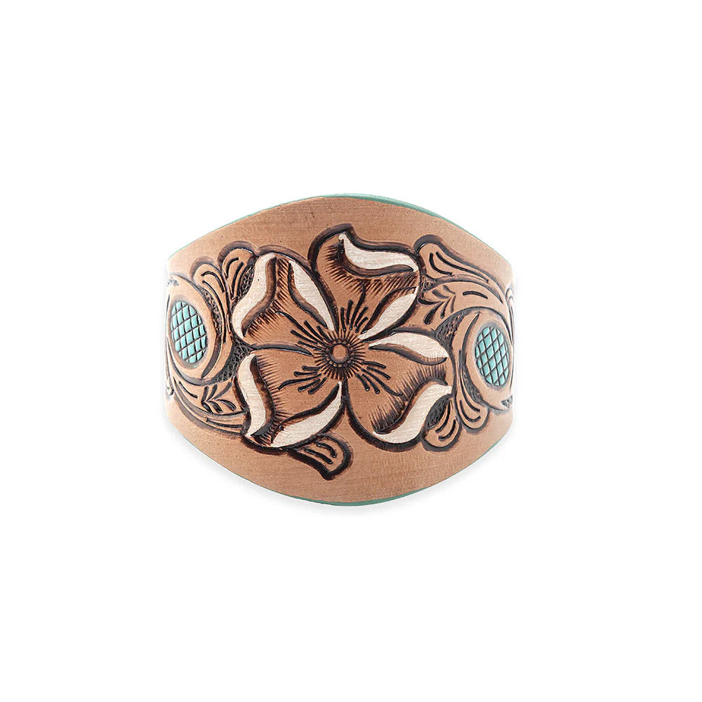 Copper bracelet with floral design and turquoise stones on a white background