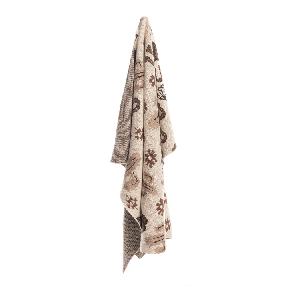Wild West Wrap Baby Blanket. Patterned fabric with cowboy boots, cacti, and horseshoes on a beige background
