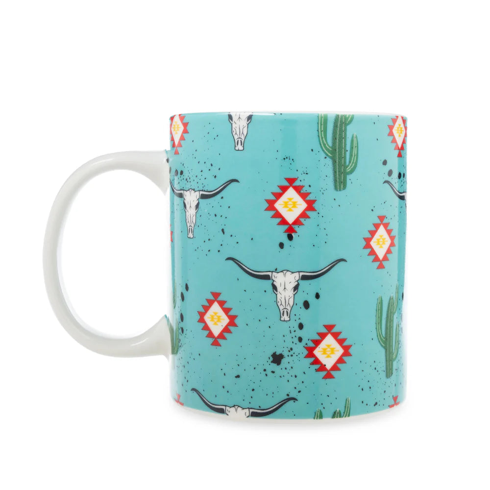 Sippin’ in the South Ceramic Mug in Cactus Geometry. Mug with southwestern design featuring cacti, longhorns, and geometric patterns on a blue background.