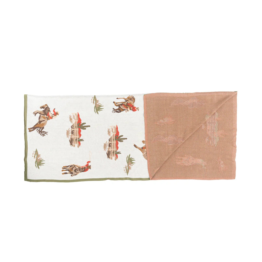 Baby blanket with animal pattern on one side and solid color on the other, on a white background