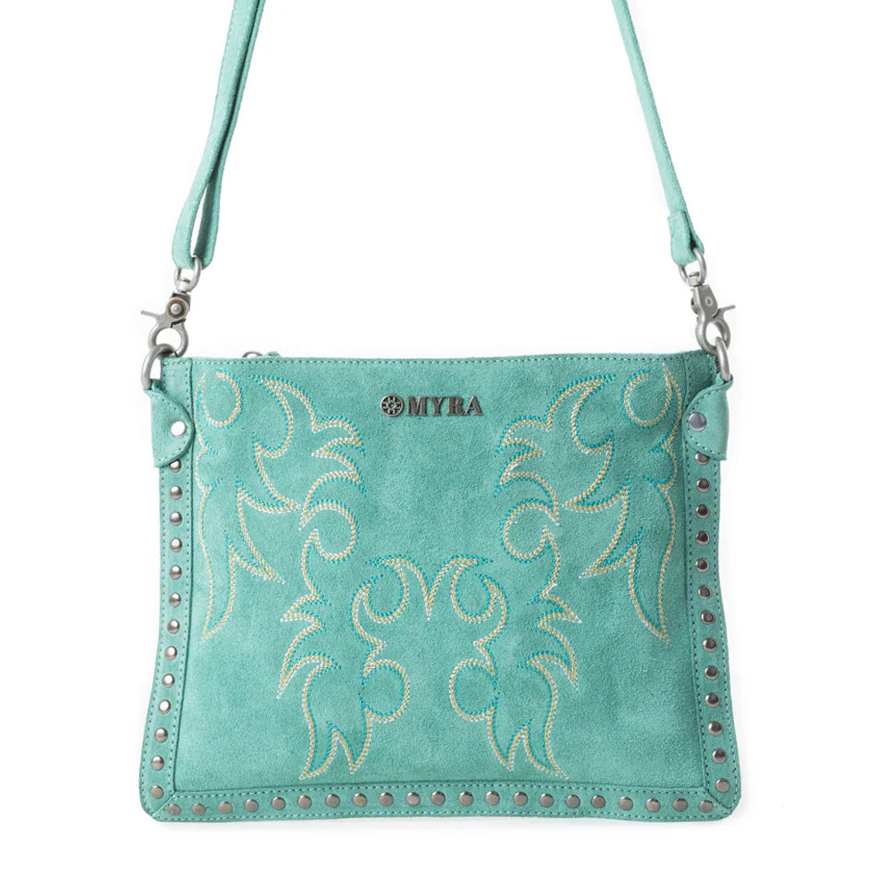 Texas Rose Western Embroidered Leather Bag in Turquoise. Teal handbag with floral patterns and studded details on a white background
