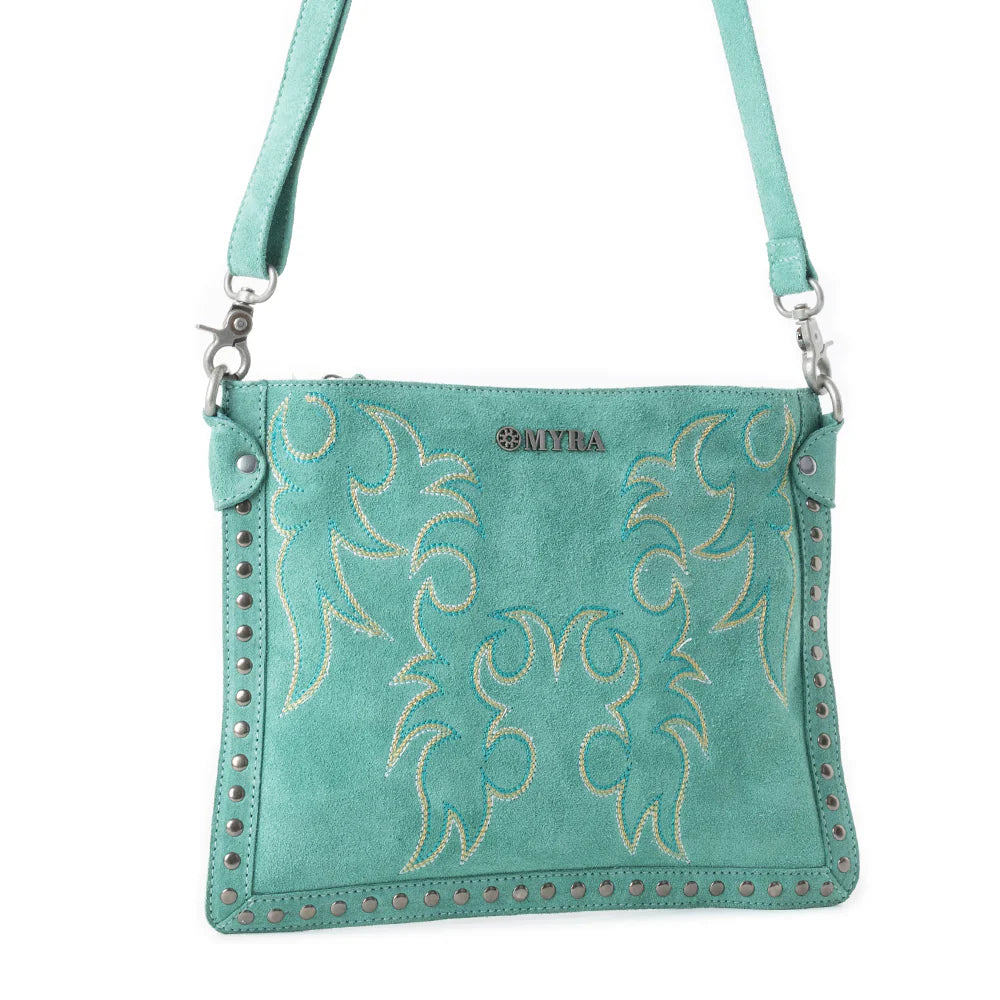 Texas Rose Western Embroidered Leather Bag in Turquoise. Teal handbag with floral patterns and studded details on a white background