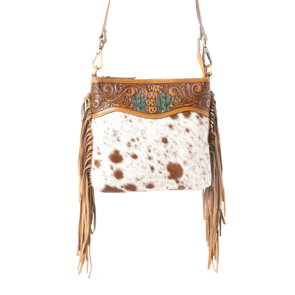 Sonora Charm Handtooled Bag in Brown &amp; White. Cowhide leather handbag with fringe and intricate tooled leather design on a white background