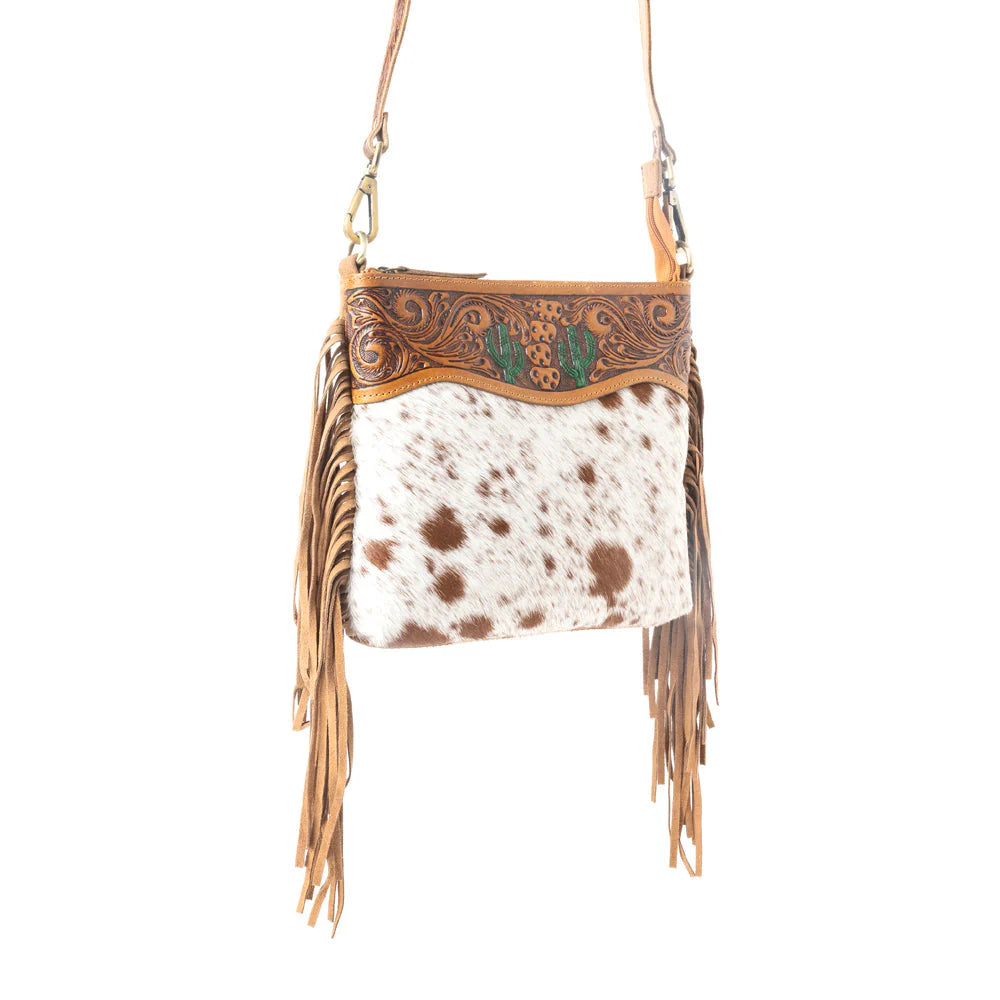 Sonora Charm Handtooled Bag in Brown & White. Cowhide leather handbag with fringe and intricate tooled leather design on a white background