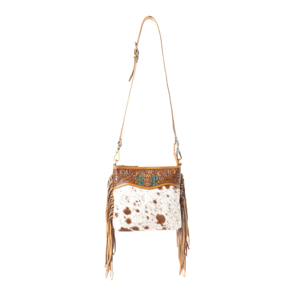 Sonora Charm Handtooled Bag in Brown & White. Cowhide leather handbag with fringe and decorative stitching on a white background