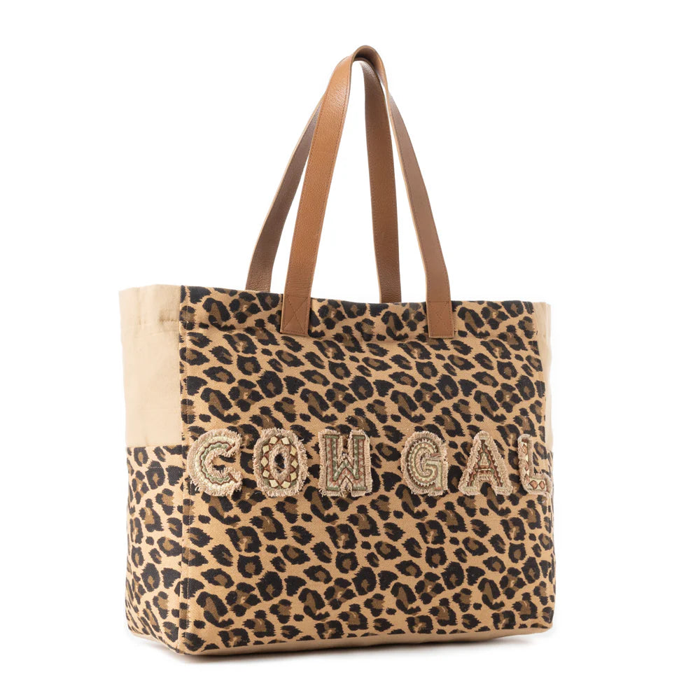 Panthera Cowgirl Weekender Bag in Jaguar Print. Leopard print tote bag with 'COOGI' branding on a white background