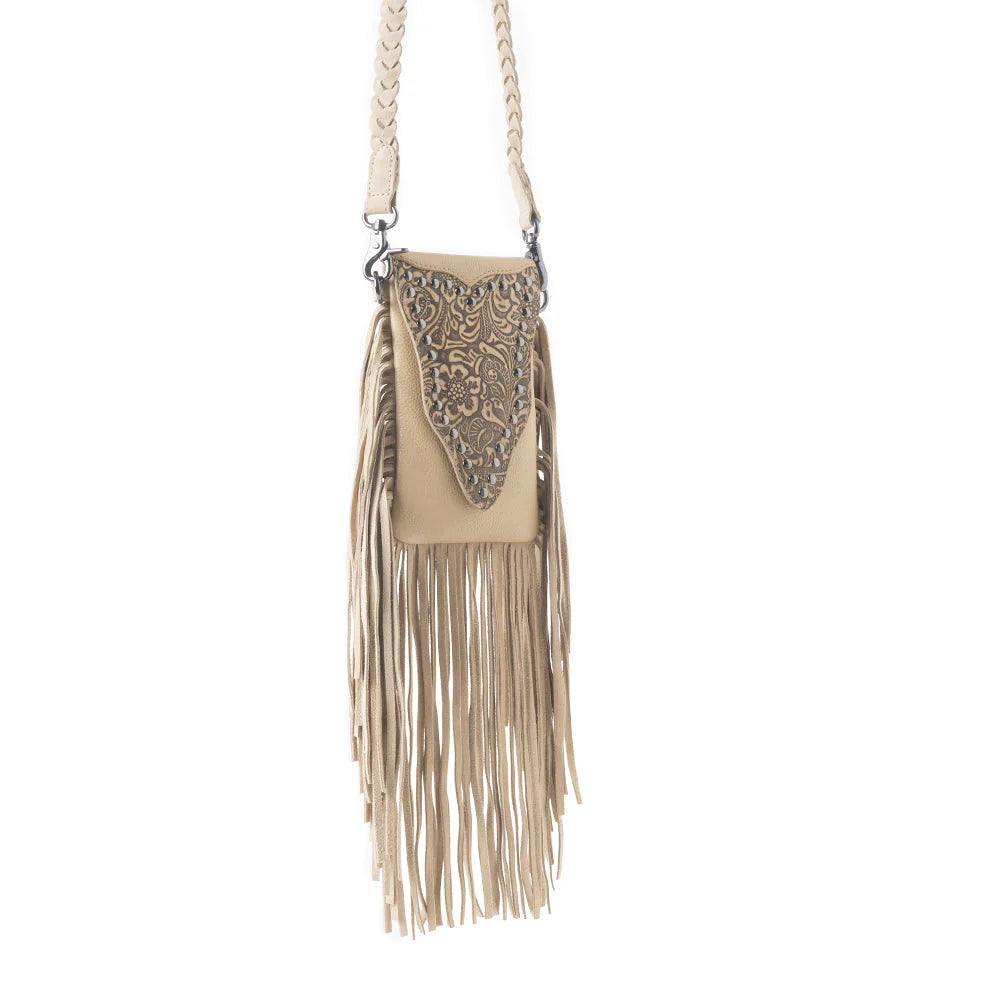 Whispering Totem Leather Western Handbag in Nomad Ivory. Beige handbag with fringe and decorative element on a white background
