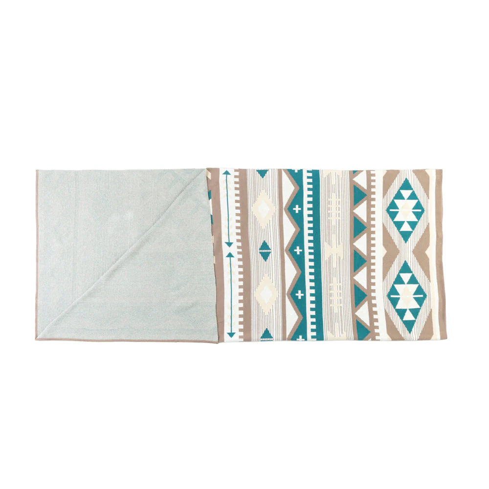 Folded towel with geometric pattern on a white background