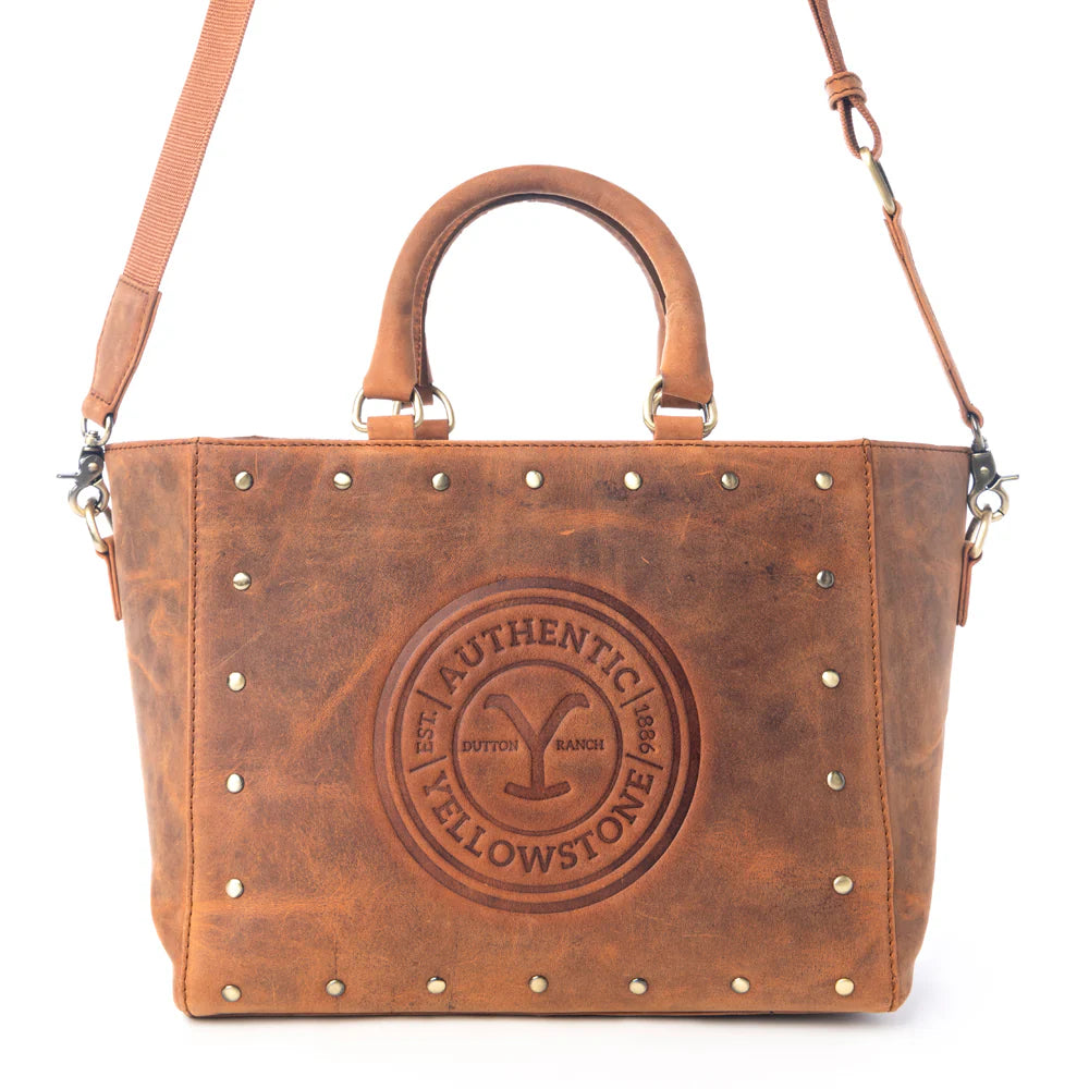 Yellowstone Valley Soul Studded &amp; Embossed Tote Leather Bag in Amber. Brown leather handbag with studded details and &#39;Authentic Yellowstone&#39; embossing on a white background