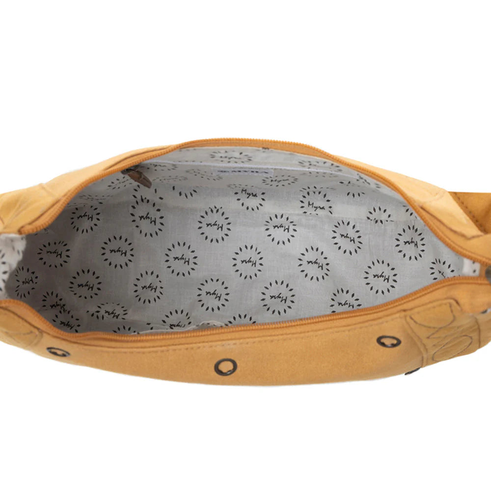 Close-up of a tan leather bag with gray interior featuring black circular patterns.