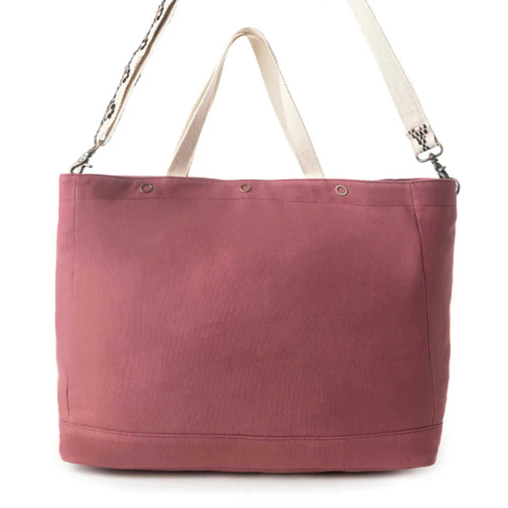 Pink tote bag with beige straps on a white background