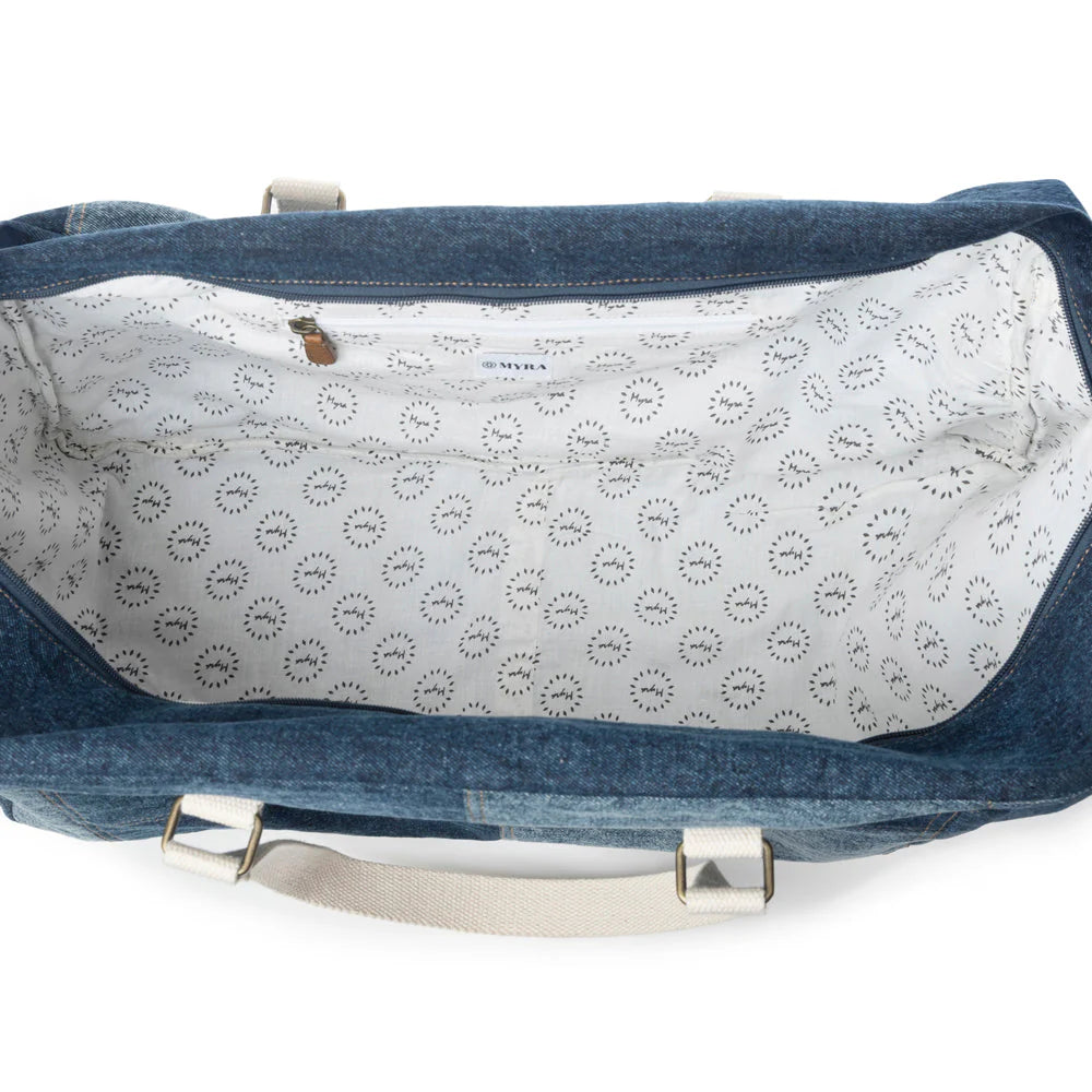 Blue denim bag with white interior featuring a pattern, on a white background
