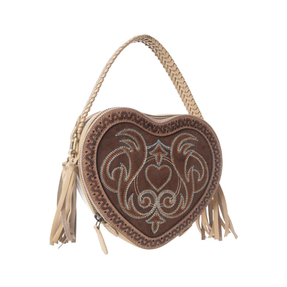 Heart-shaped handbag with intricate embroidery and tassels on a white background